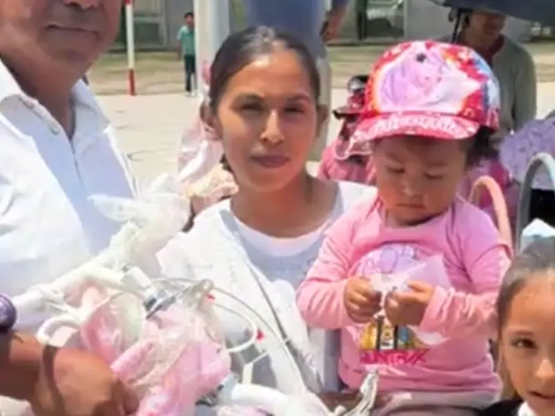 A parent and child receiving a gift