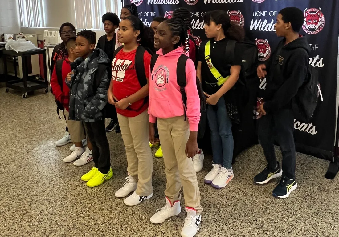 Teamwork Cares volunteers with students