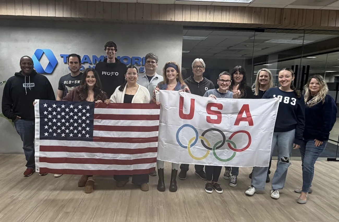 The team with the USA Olympic flag in the office